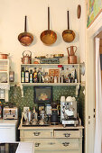 Pans on wall above shelves in kitchen