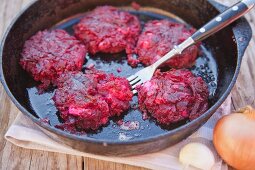 Beetroot meatballs in a pan