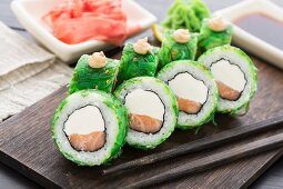 Salmon sushi rolls covered with chuka seaweed