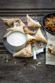 Spicy chicken, atchar and Brie samosas with a sour cream and coriander dip