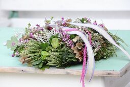 Autumnal wreath of flowers, ribbons and pink lace