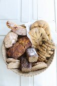 Various homemade breads in a bread basket (top view)