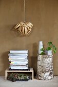 Lampshade made from wood veneer above stacked magazines and tree stump