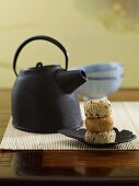 A teapot and sticky rice balls with sesame seeds (Japan)
