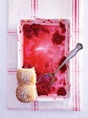 Raspberry buchteln in a baking dish, almost eaten (top view)