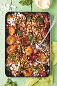 Peach and strawberry crumble with pistachios and coconut flakes