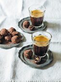 Chocolate nut truffles and coffee in a glass