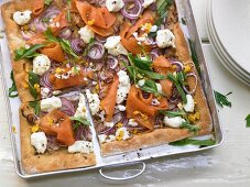 Pizza with smoked salmon, ricotta and rocket
