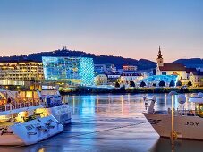 The illuminated Ars Electronica (Museum of the Future) and the River Danube in Linz, Austria