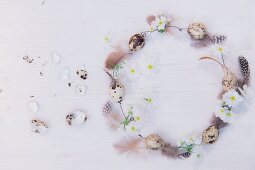 Romantic wire wreath, quail eggs, feathers and white flowers