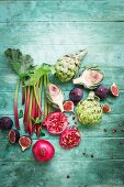 Still life with rhubarb, artichokes, pomegranate and figs