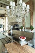 Rustic wood, stainless steel and chandelier in kitchen