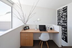 Modern, black and white wall hanging next to fitted desk on gallery