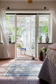 Open lattice doors leading to sunny terrace