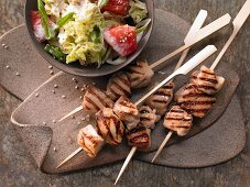 Teriyaki chicken skewers with a bok choy and grapefruit salad