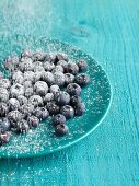 Blueberries on blue plate on blue table