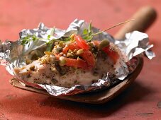 Italian chicken in foil with tomatoes, capers and oregano