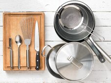 Various kitchen utensils: pot, pan, sieve, spatula