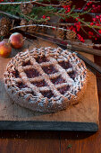 Linzer Torte (nut and jam layer cake) and bunches of holly berries