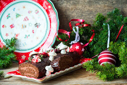 A chocolate yule log topped with meringue mushrooms for Christmas