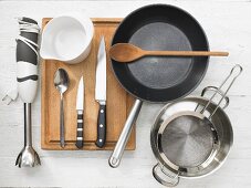 Various kitchen utensils: blender, pan, pot, strainer, mixing jug