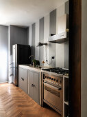 Grey and white striped wall in kitchen with free-standing elements