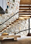 Sculptural staircase made of oak wood and with metal bars as a balustrade