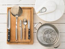 Kitchen utensils for making fish with a vegetable salad