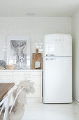 Retro-Kühlschrank in der Küche in Weiß mit Holzaccessoires
