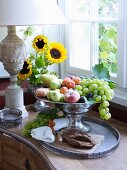 Opulent fruit bowl on tray next to window