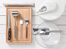Kitchen utensils for making beef carpaccio with mushrooms, rocket and Parmesan