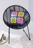 A denim cushion cover with felt flowers