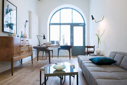 Arched window and Scandinavian designer furniture in living room