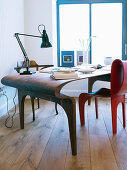 Wooden desk and red chairs in futuristic design