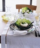 Set table decorated with cheese in cabbage leaves