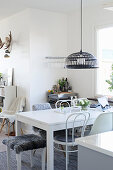 White table and various chairs in open-plan interior