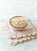 Organic barley flakes in a ceramic bowl