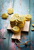 Savoury curry and poppyseed pinwheels on a chopping board