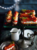 Eclairs with cream, fresh strawberries and pistachios