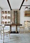 Industrial-style dining area with concrete floor and metal furniture