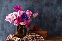 Bouquet of spring flowers against black wall
