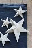 Folded white paper stars with zig-zag edges
