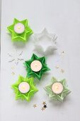Folded green paper stars used as tealight holders