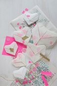Translucent origami hearts with confetti on printed paper
