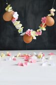 Garland of threaded paper flowers and eggs