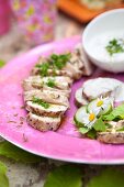 Grilled pork tenderloin slices with herbs and cold yoghurt sauce