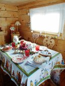 Festively set table in rustic wooden cabin