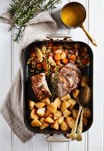 Roast pork with baked potatoes, apple, vegetables and cider sauce
