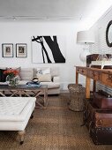 Sisal rug, wicker stools and pale sofa in country-house-style living area