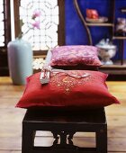 Embroidered cushions on wooden bench